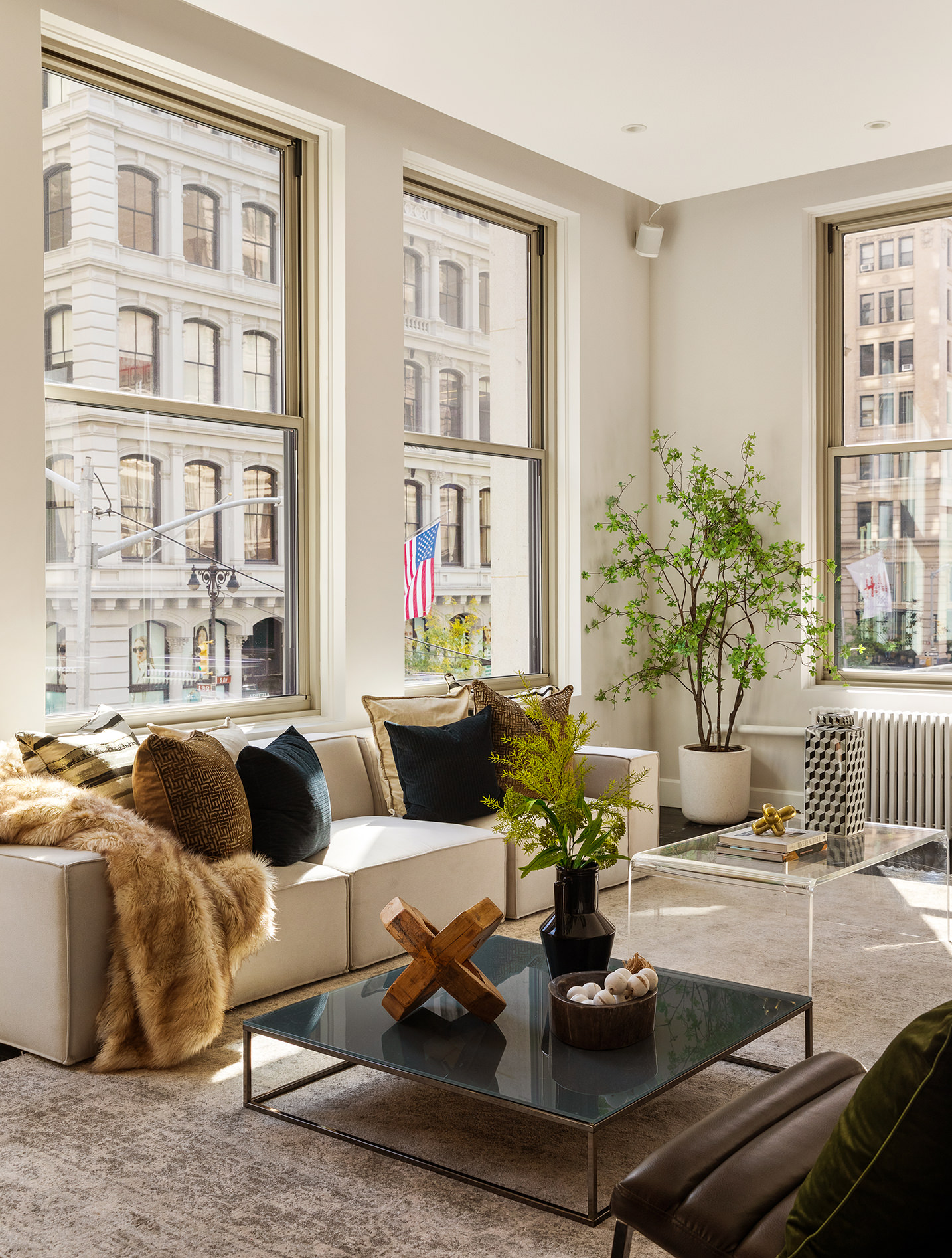 142 5th Avenue, Unit 2 Manhattan, NY 10011 - Photo 4 of 18 a living room with furniture and a potted plant