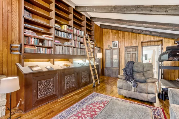 a kitchen with a sink and wooden floor