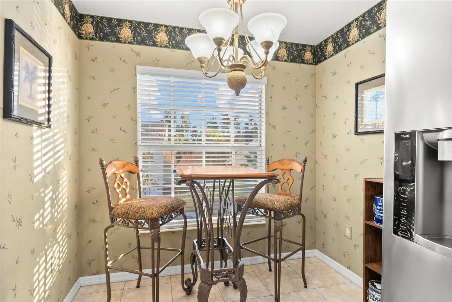 a view of a dining room with furniture and a floor to ceiling window