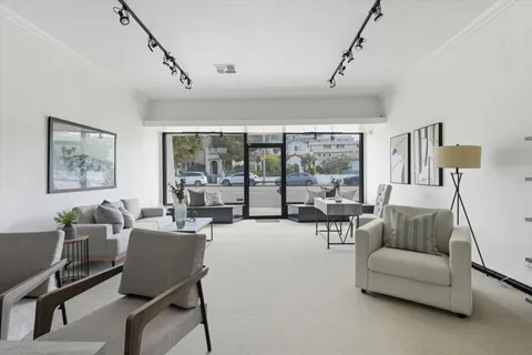 a dining room with furniture a livingroom and chandelier