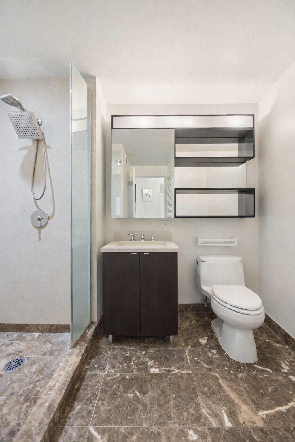 215-217 East 96th Street, Unit 26F Manhattan, NY 10128 - Photo 7 of 19 a bathroom with a granite countertop sink a toilet and a mirror