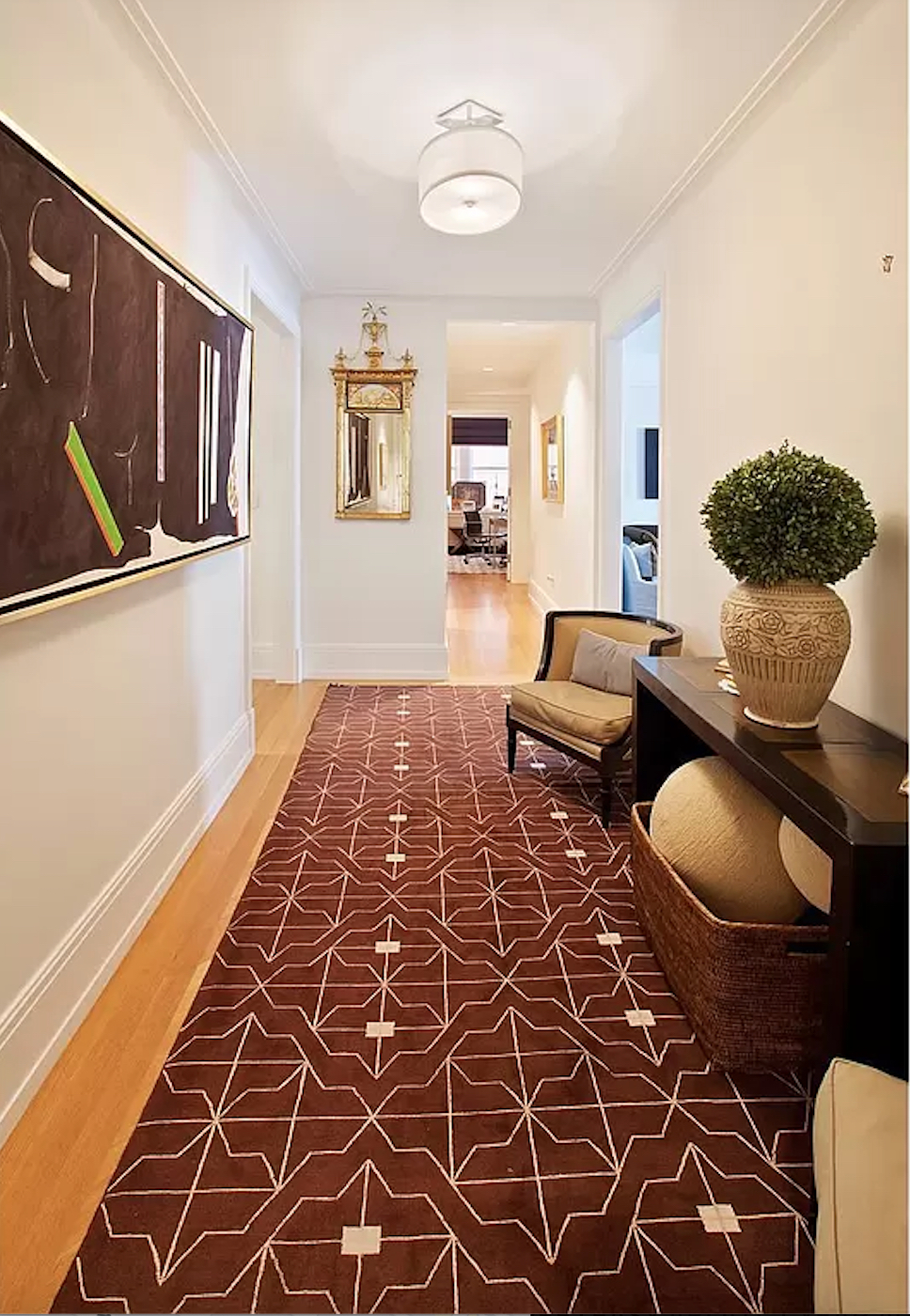 40 East 66th Street, Unit 8C Manhattan, NY 10065 - Photo 2 of 16 a living room with a couch and a rug