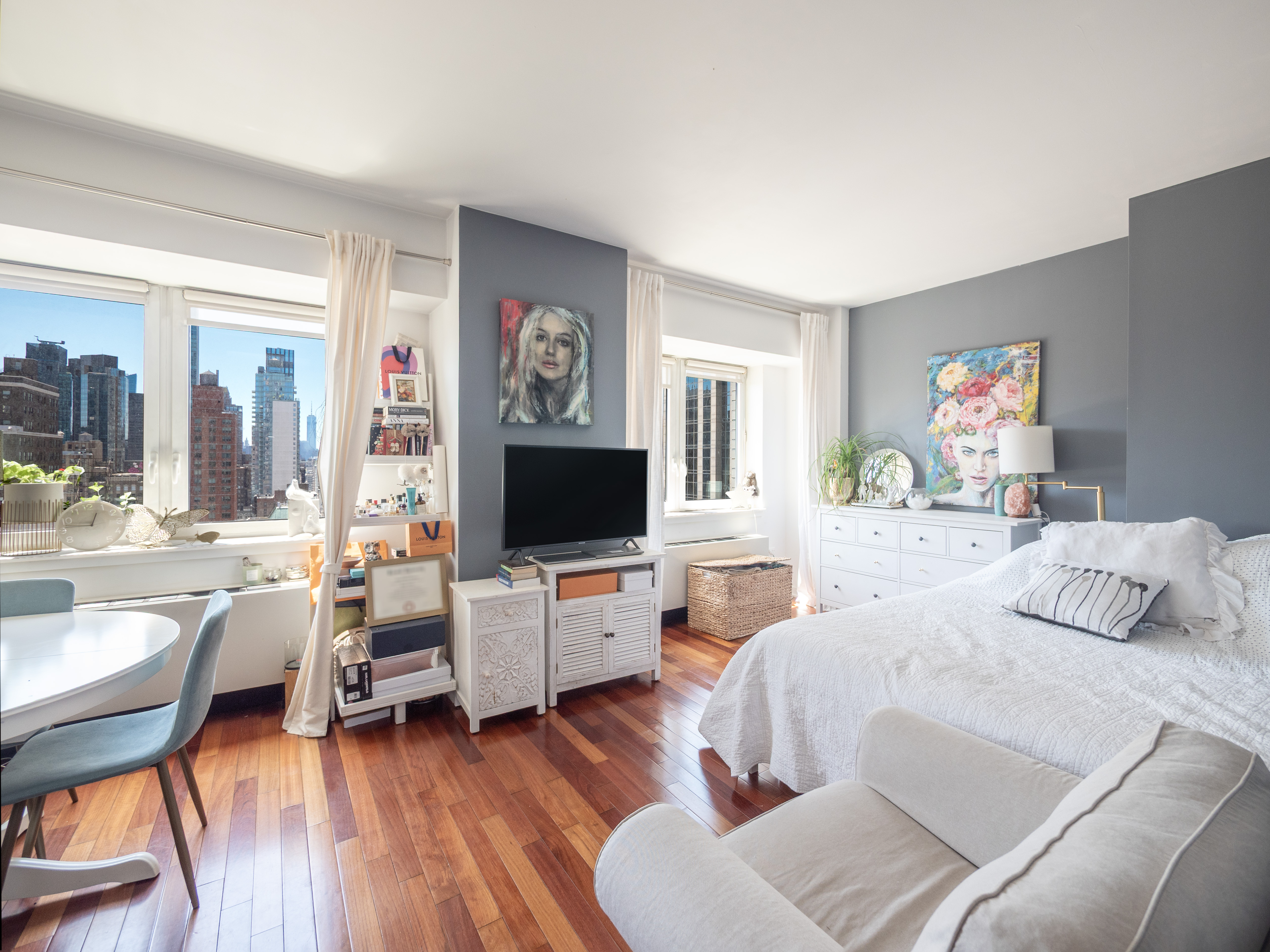 425 5th Avenue, Unit 31C Manhattan, NY 10016 - Photo 1 of 6 a bedroom with furniture and a flat screen tv