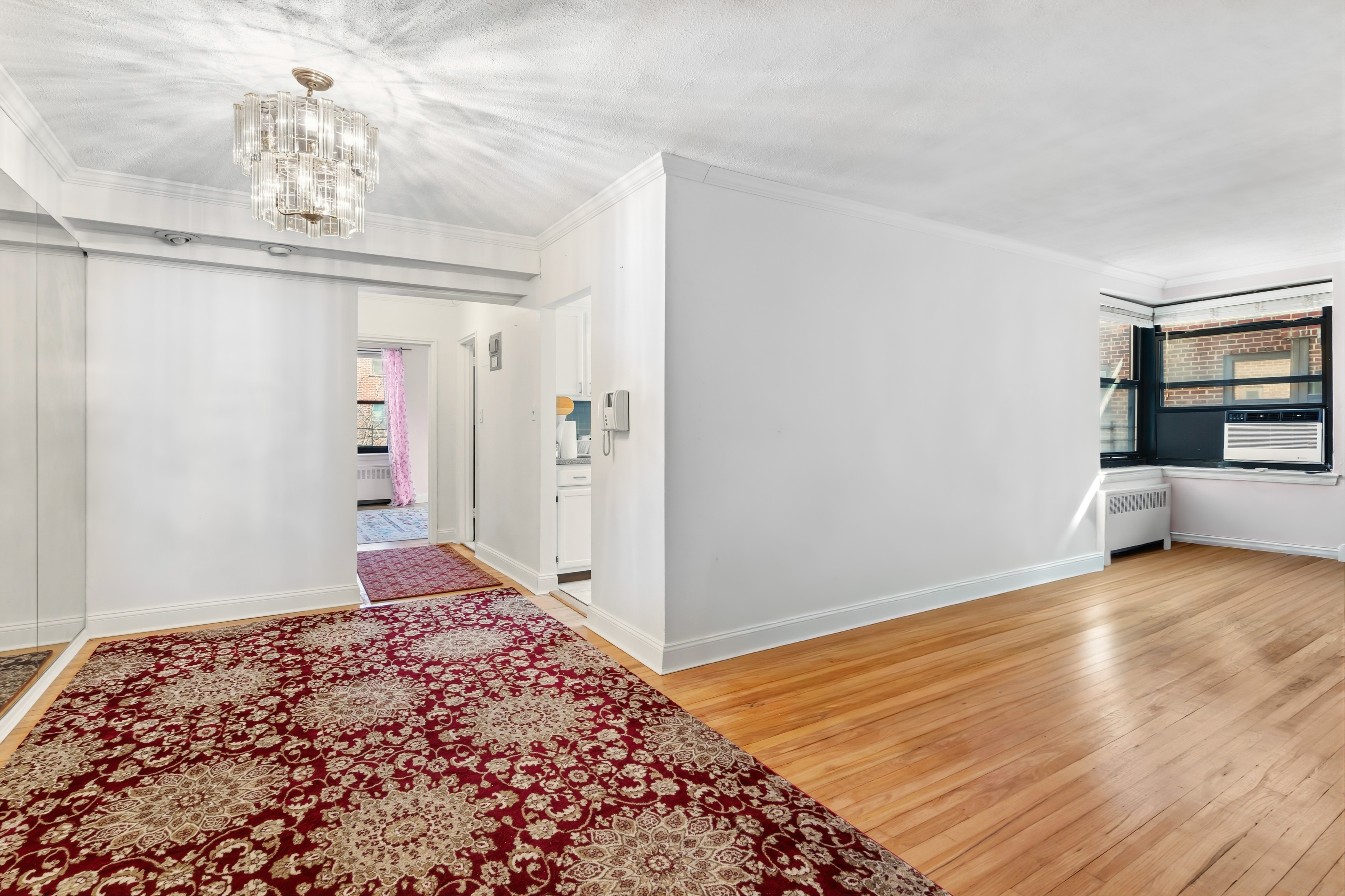 32-40 91st Street, Unit 510 Queens, NY 11369 - Photo 1 of 5 a view of a hallway with a chandelier