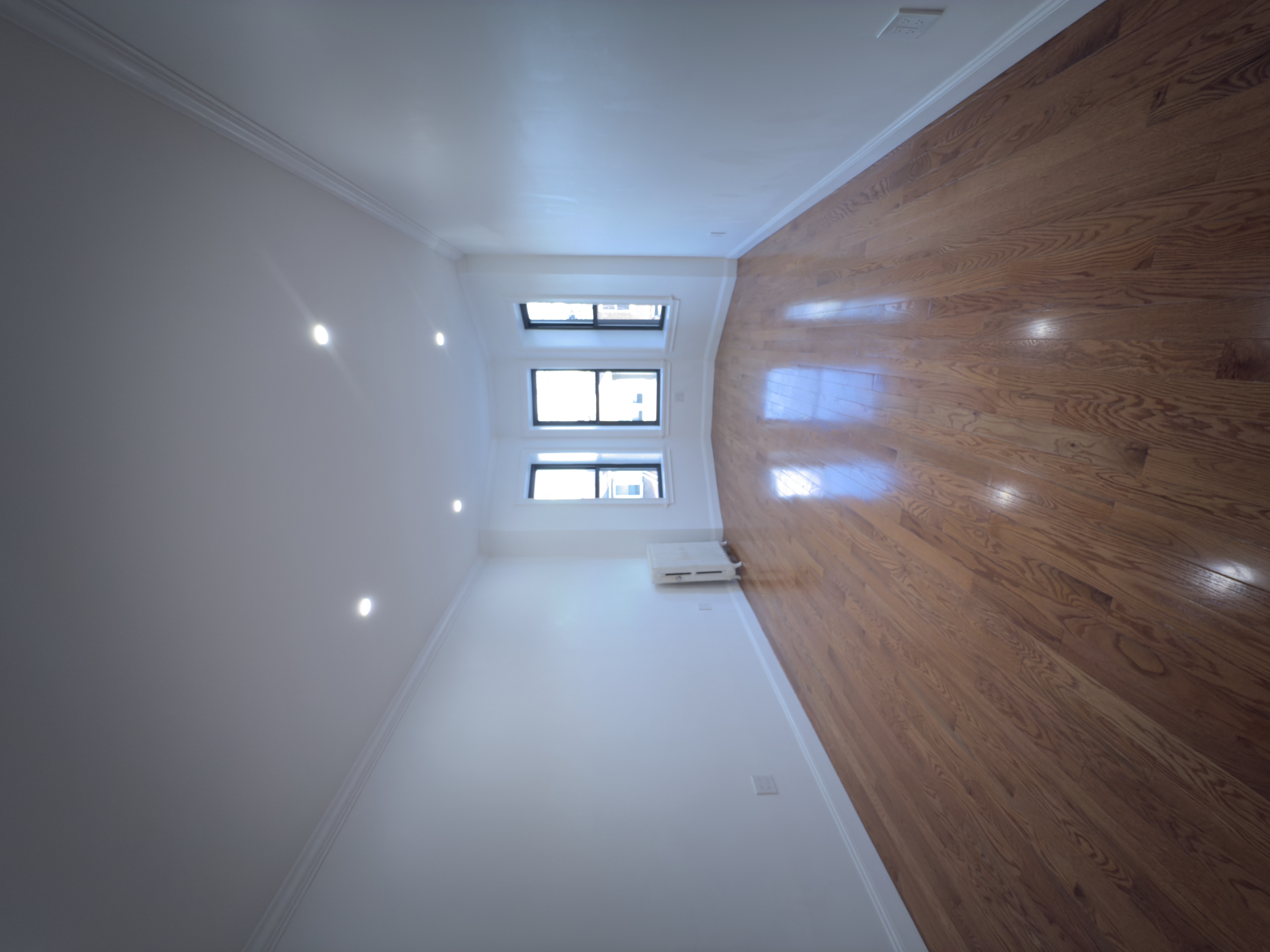 82 74th Street Brooklyn, NY 11209 - Photo 11 of 21 a view of empty room with wooden floor and fan