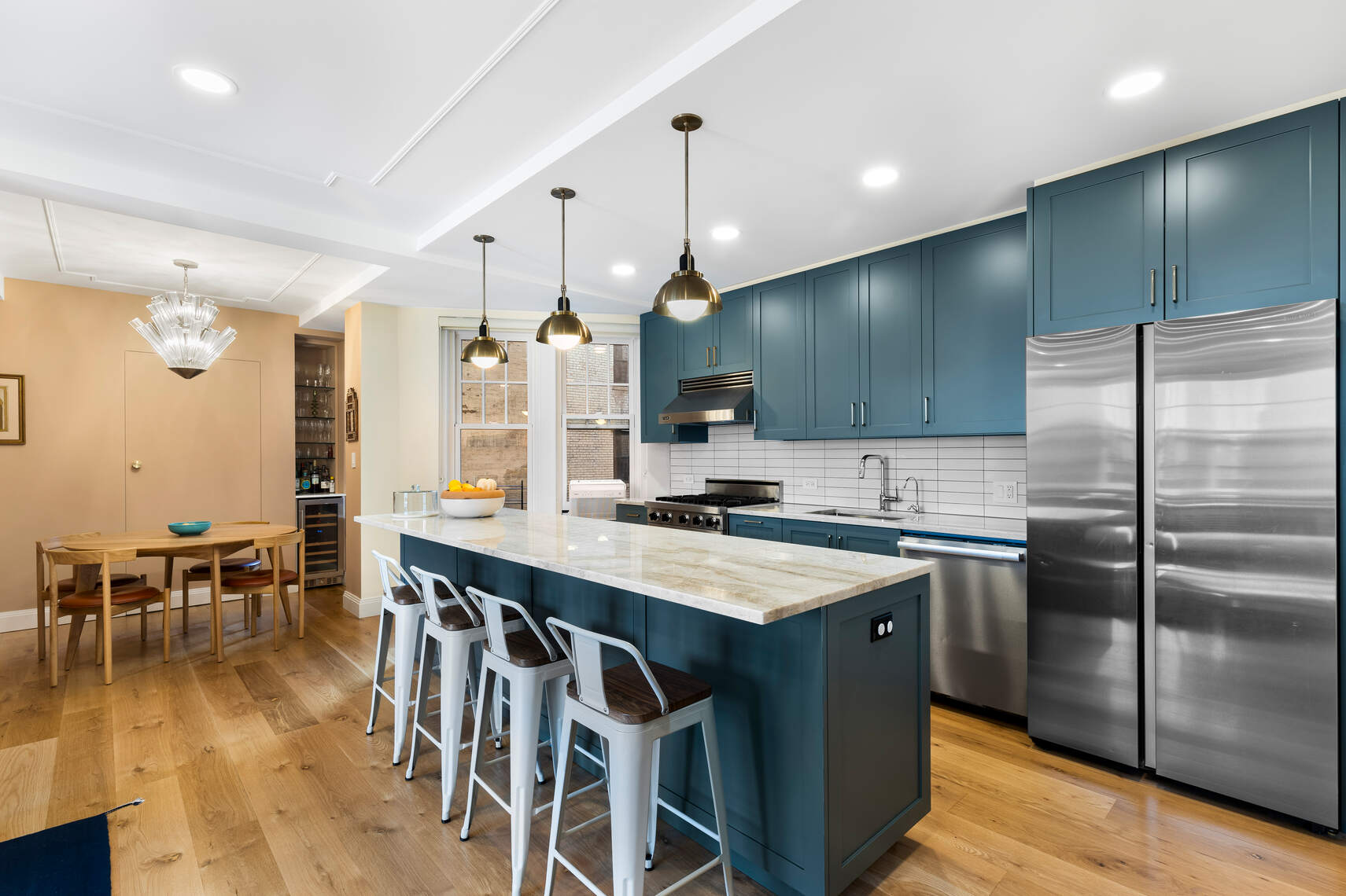 47 Plaza Street West, Unit 5B Brooklyn, NY 11217 - Photo 3 of 14 a kitchen with stainless steel appliances granite countertop a table chairs wooden floors and a view of living room