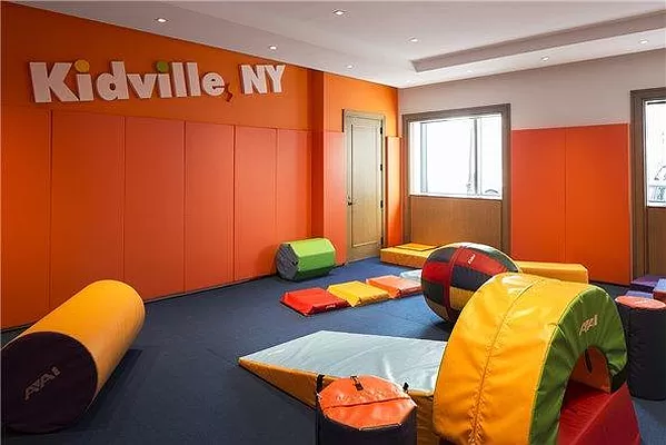 60 Riverside Boulevard, Unit 3003 Manhattan, NY 10069 - Photo 13 of 17 a blue bed sitting in a room next to a window