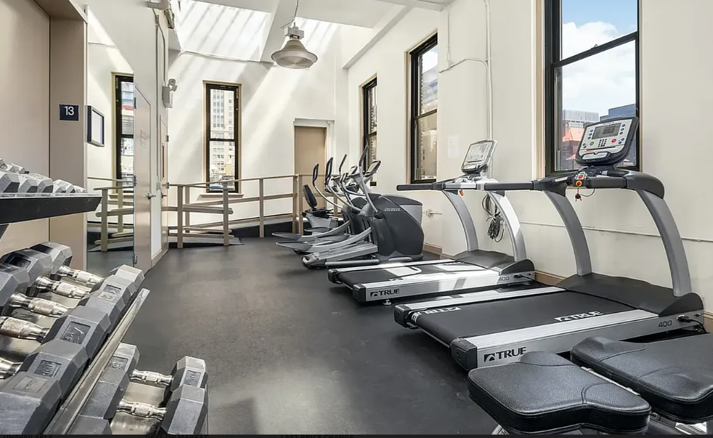 11 East 36th Street, Unit 1203 Manhattan, NY 10016 - Photo 7 of 8 a room with gym equipment and a large window