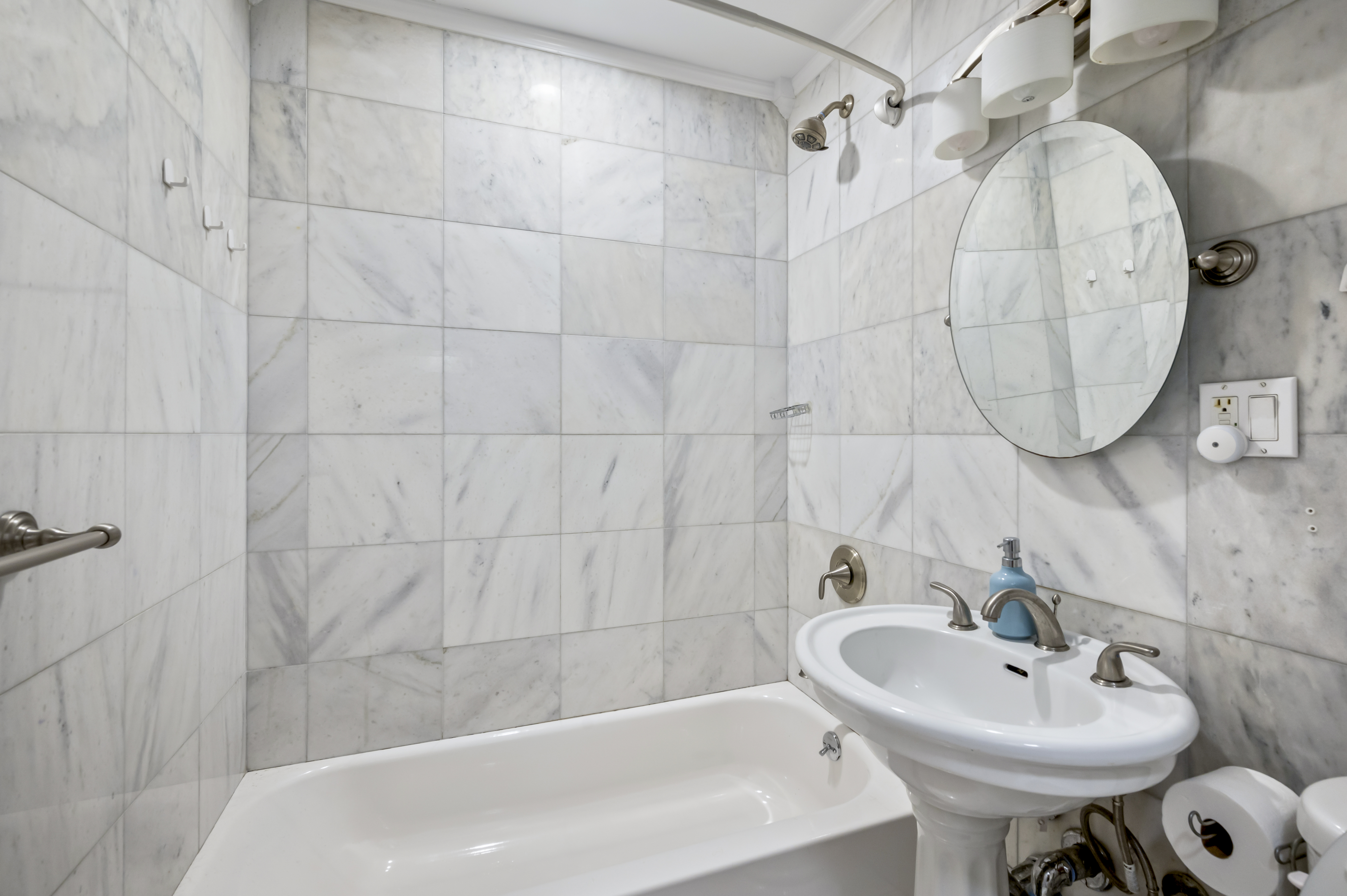 53 West 94th Street Manhattan, NY 10025 - Photo 6 of 12 a bathroom with a sink a mirror and a shower