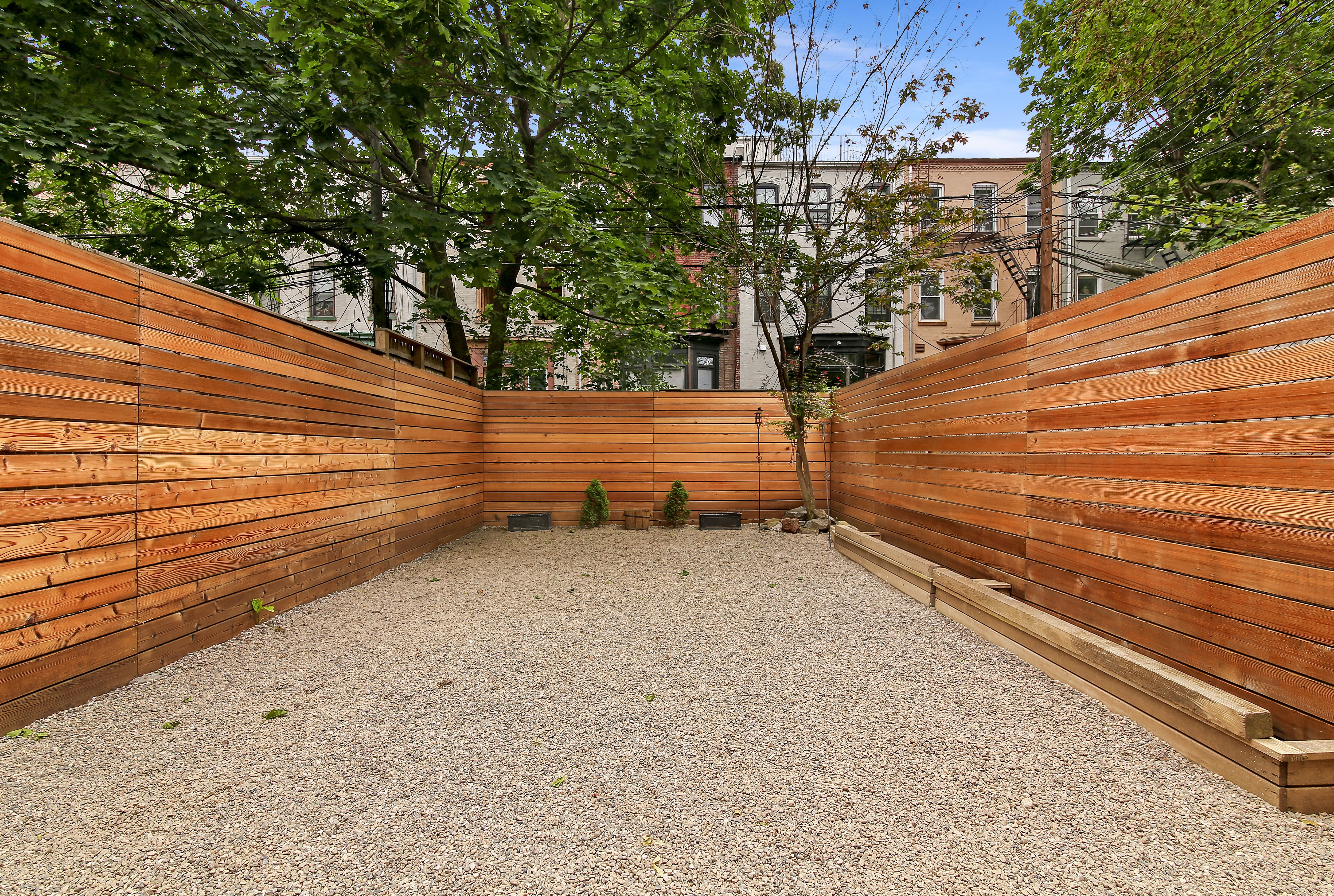666 Putnam Avenue, Unit 1 Brooklyn, NY 11221 - Photo 7 of 8 a view of a yard with wooden fence