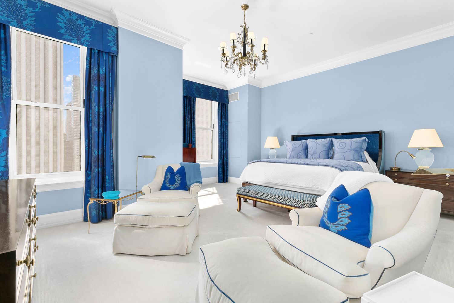 1 Central Park South, Unit 913 Manhattan, NY 10019 - Photo 4 of 23 a bedroom with a large bed and a chandelier
