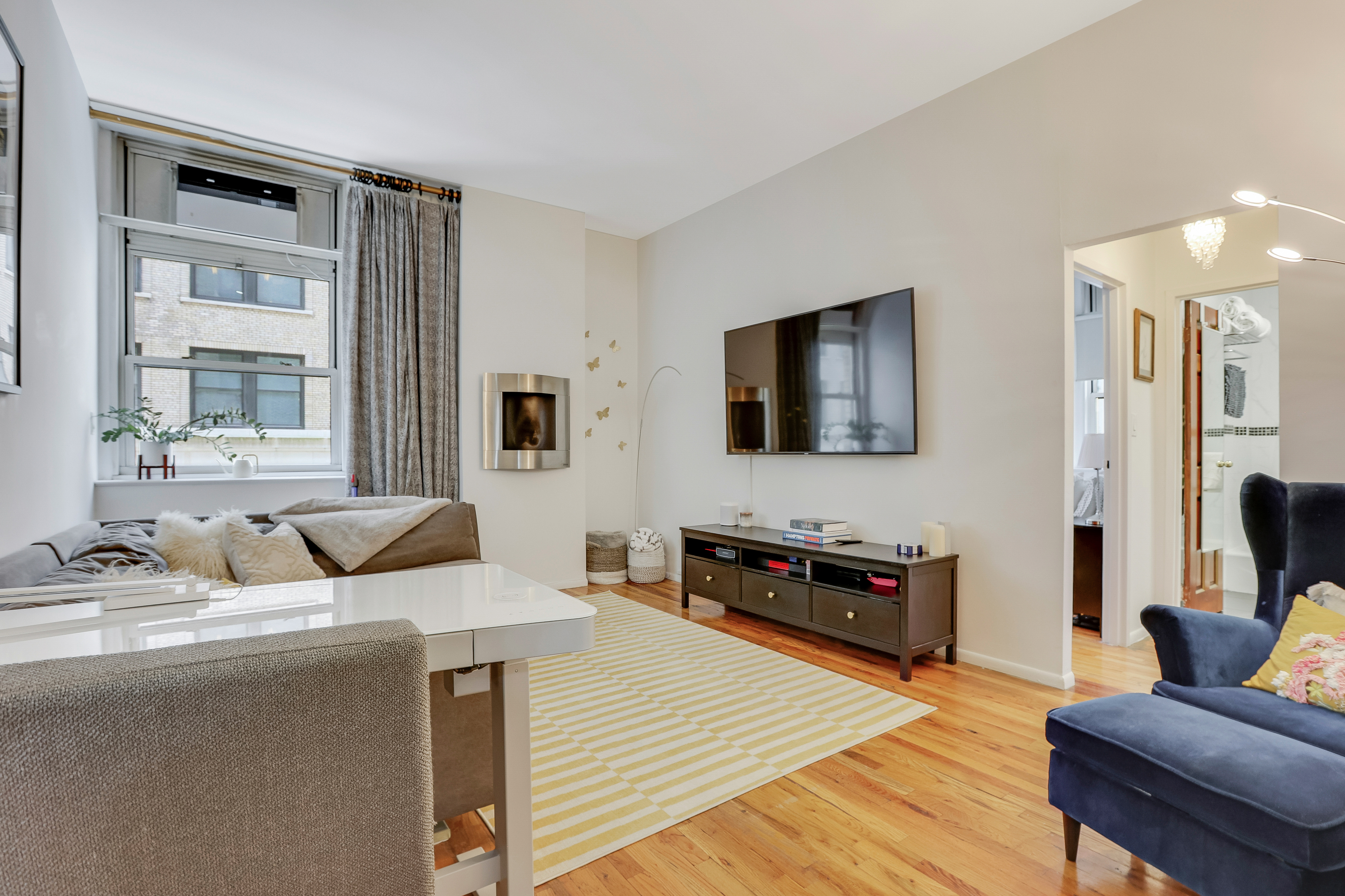 159 Madison Avenue, Unit 4G Manhattan, NY 10016 - Photo 1 of 14 a living room with furniture and a flat screen tv