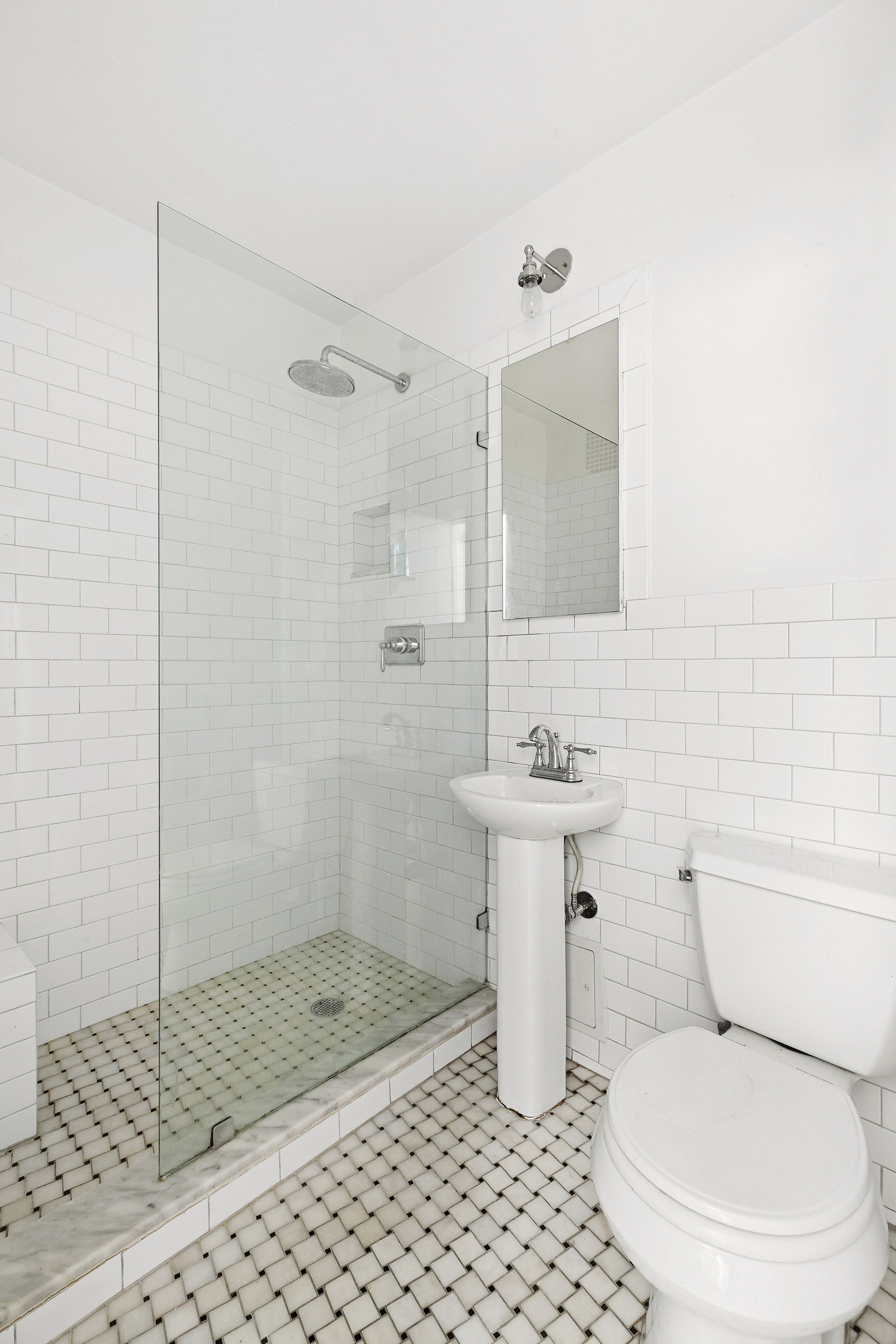 32 Downing Street, Unit 3D Manhattan, NY 10014 - Photo 3 of 4 a bathroom with a toilet a sink and a shower