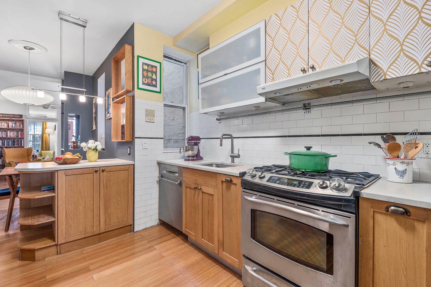 a kitchen with stainless steel appliances white cabinets and a stove top oven