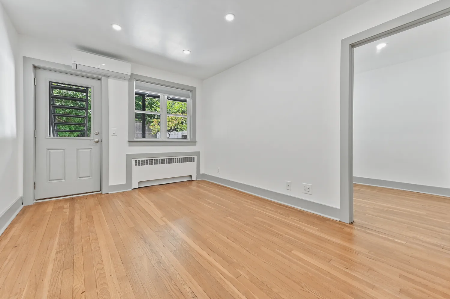 wooden floor in an empty room with a window