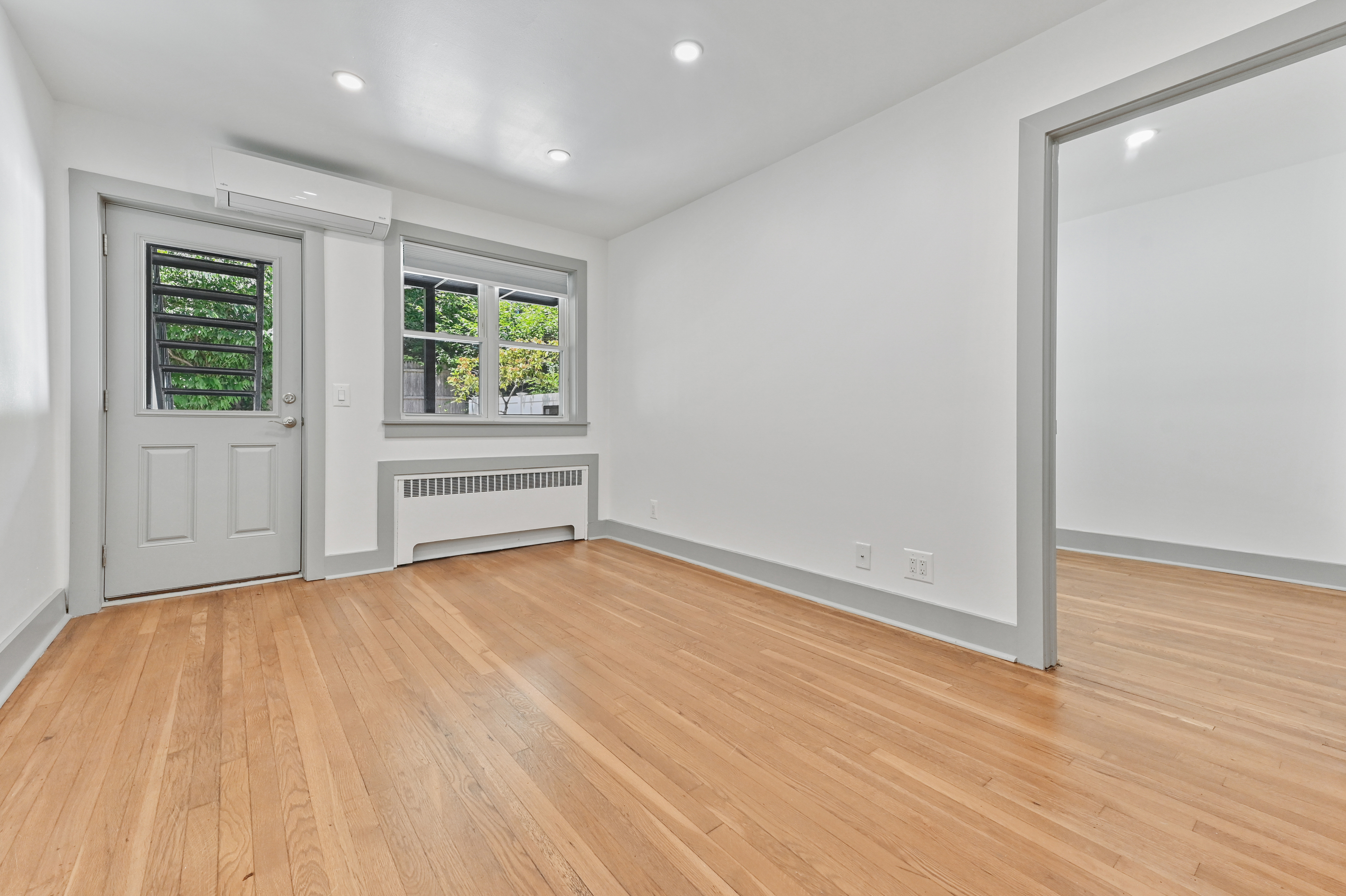 5823 Fieldston Road, Unit 1A Bronx, NY 10471 - Photo 12 of 26 wooden floor in an empty room with a window