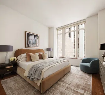 a bedroom with a large bed and a couch