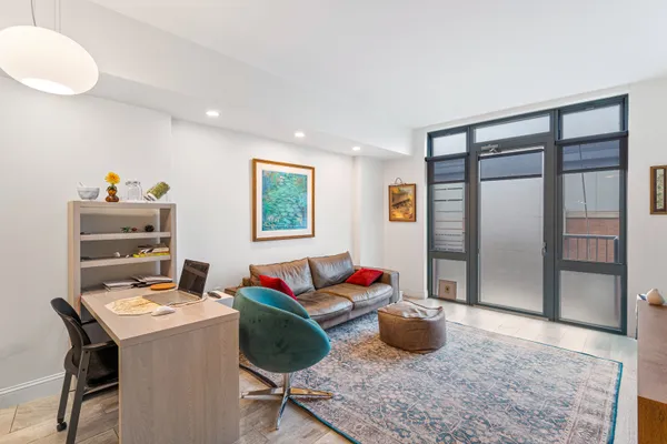 a workspace with furniture window and wooden floor