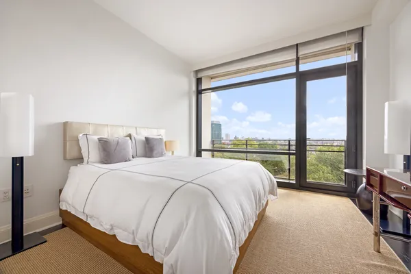 a bedroom with a large bed and a large window