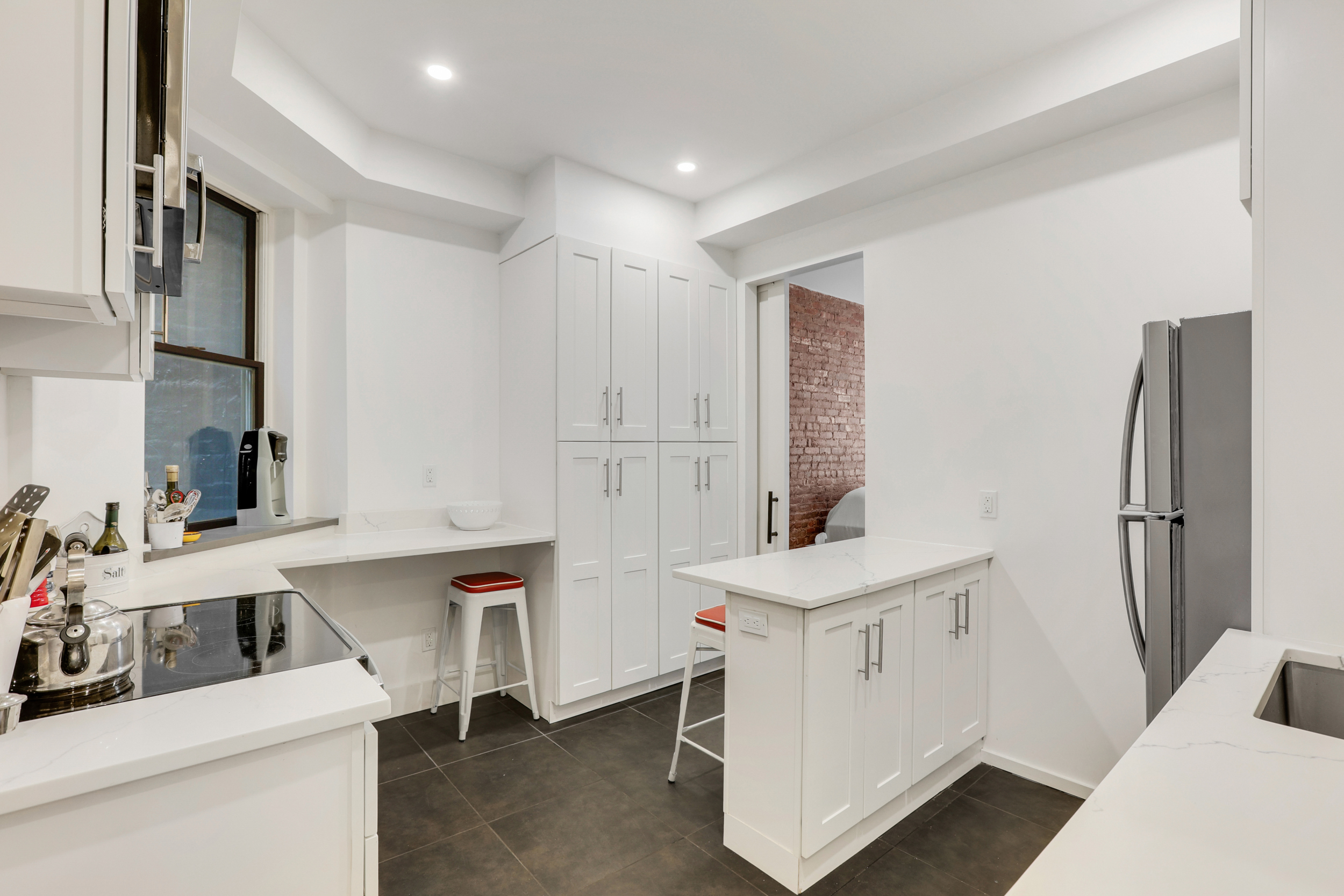 252 East 7th Street, Unit 7/8 Manhattan, NY 10009 - Photo 6 of 13 a room with a window and dryer