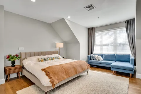 a bedroom with a bed and a couch