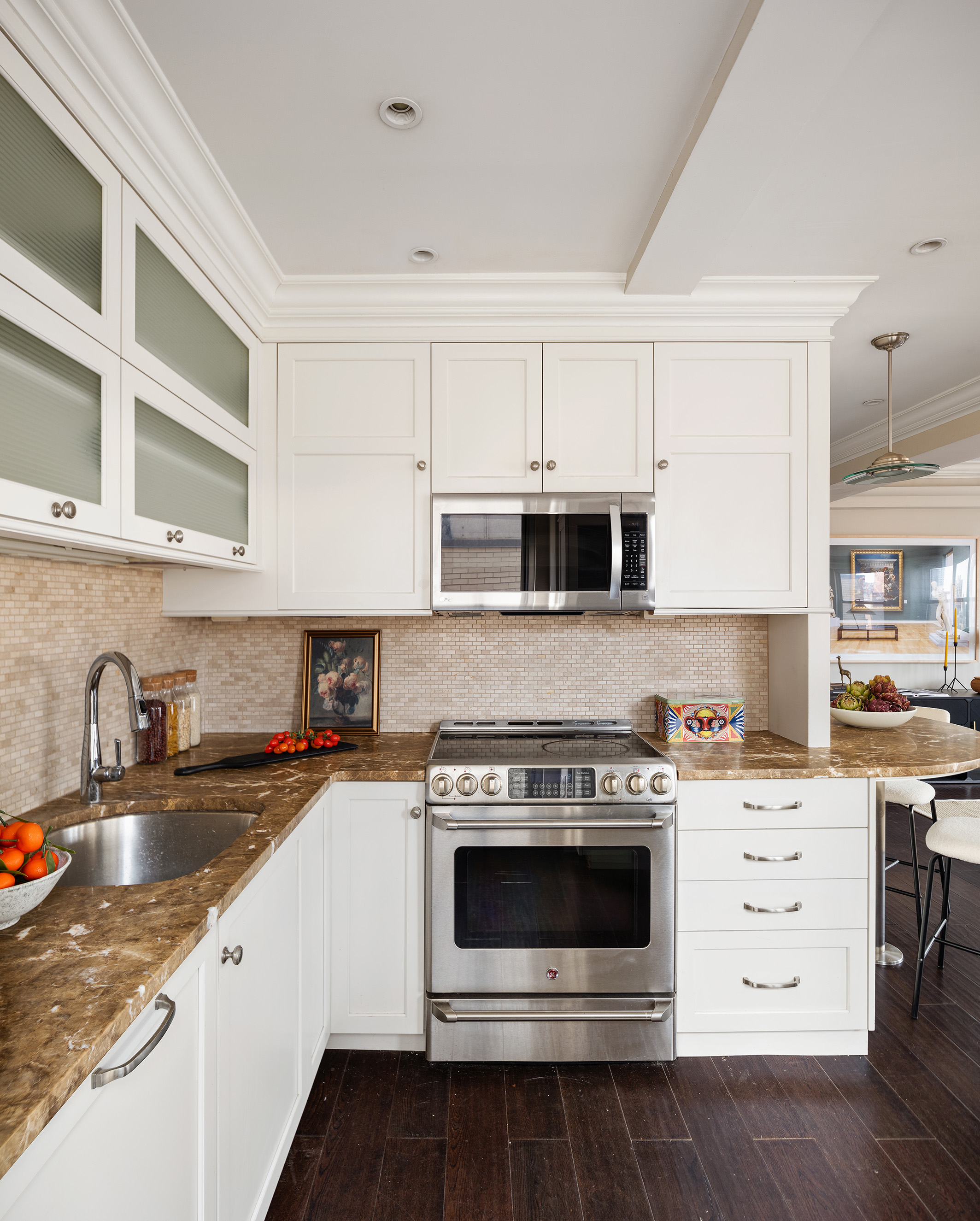 80 Park Avenue, Unit 19N Manhattan, NY 10016 - Photo 11 of 20 a kitchen with stainless steel appliances granite countertop a stove a sink and a microwave
