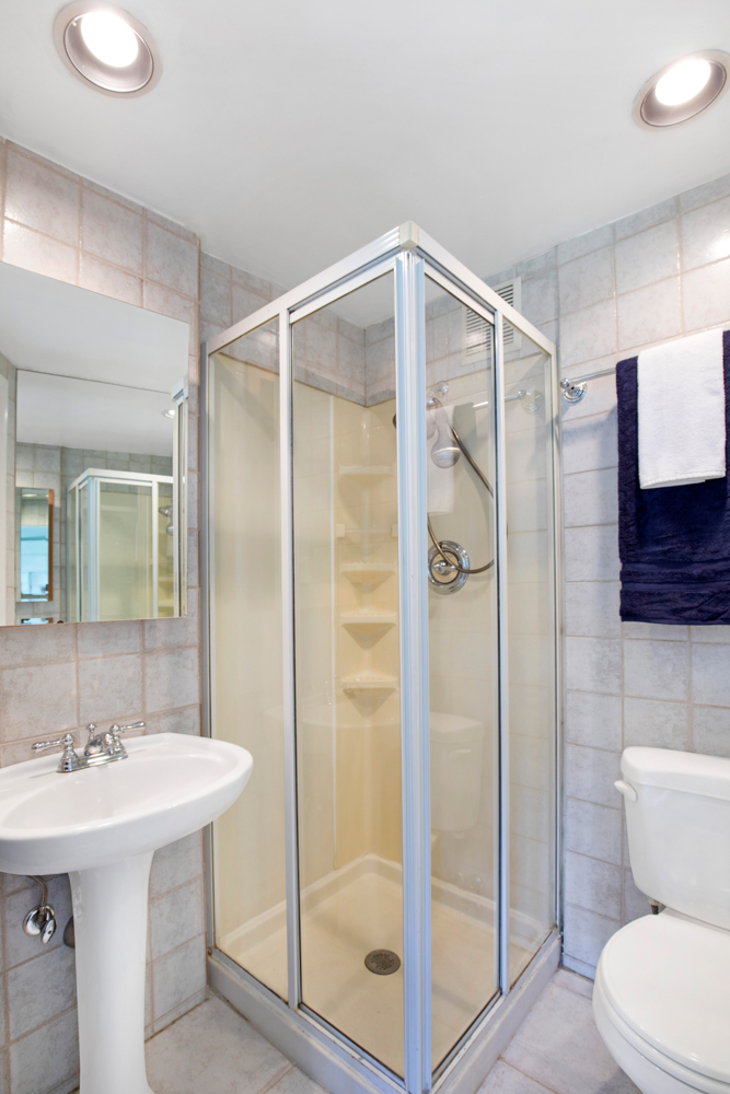 40 West 76th Street, Unit 10 Manhattan, NY 10023 - Photo 6 of 7 a bathroom with a shower sink vanity and toilet