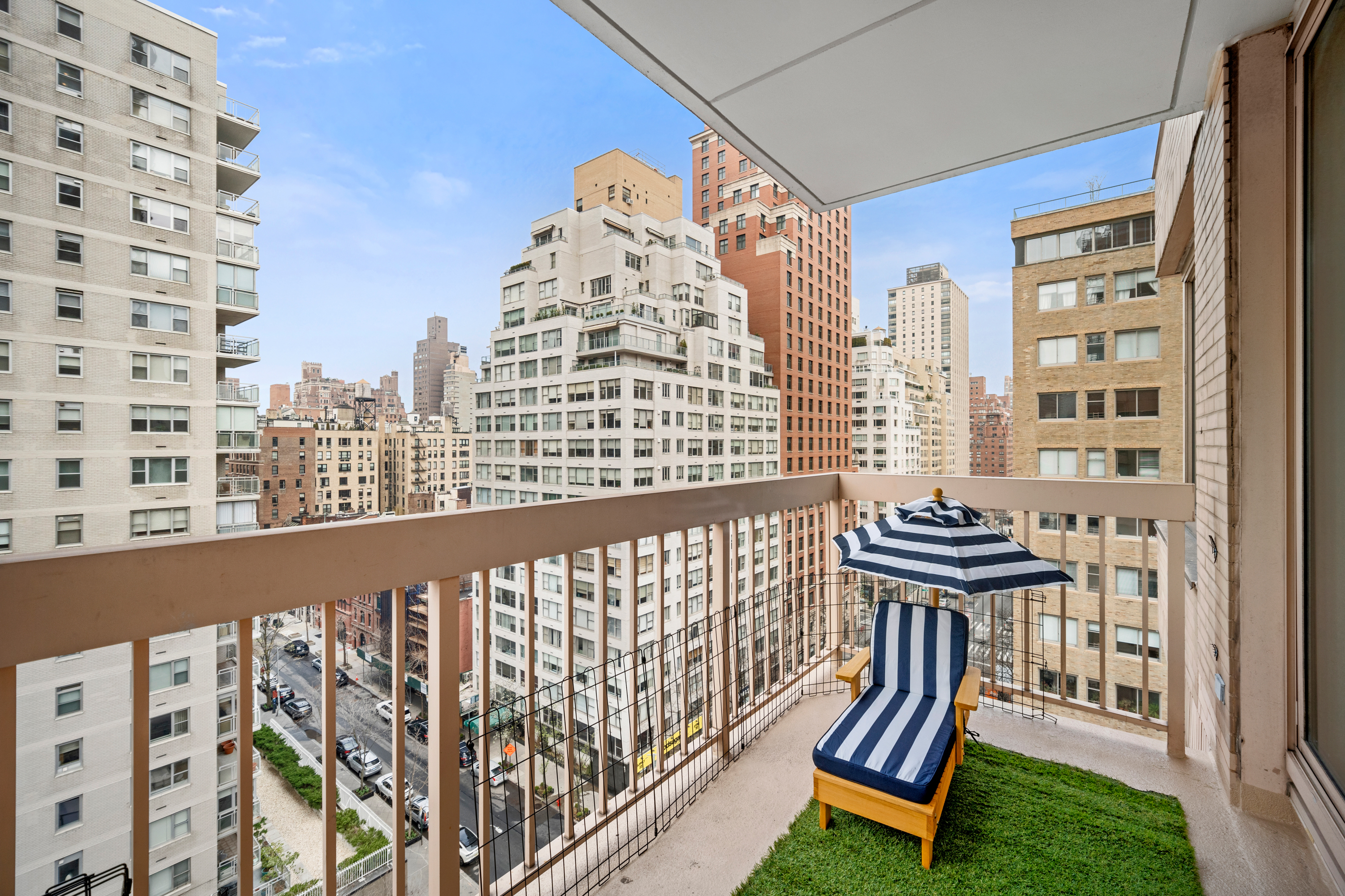 200 East 69th Street, Unit 12E Manhattan, NY 10021 - Photo 4 of 6 a view of a balcony with chair and iron fence