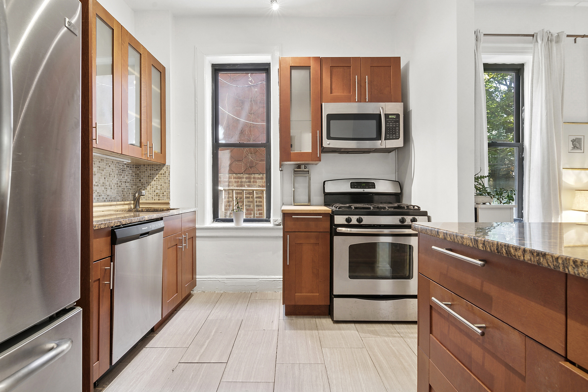 368 State Street, Unit 2 Brooklyn, NY 11217 - Photo 3 of 6 a kitchen with a stove and a microwave
