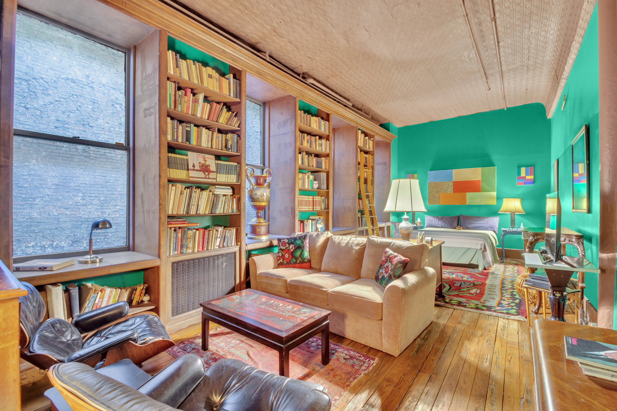 69 Wooster Street, Unit 3 Manhattan, NY 10012 - Photo 11 of 22 a living room with furniture and a flat screen tv