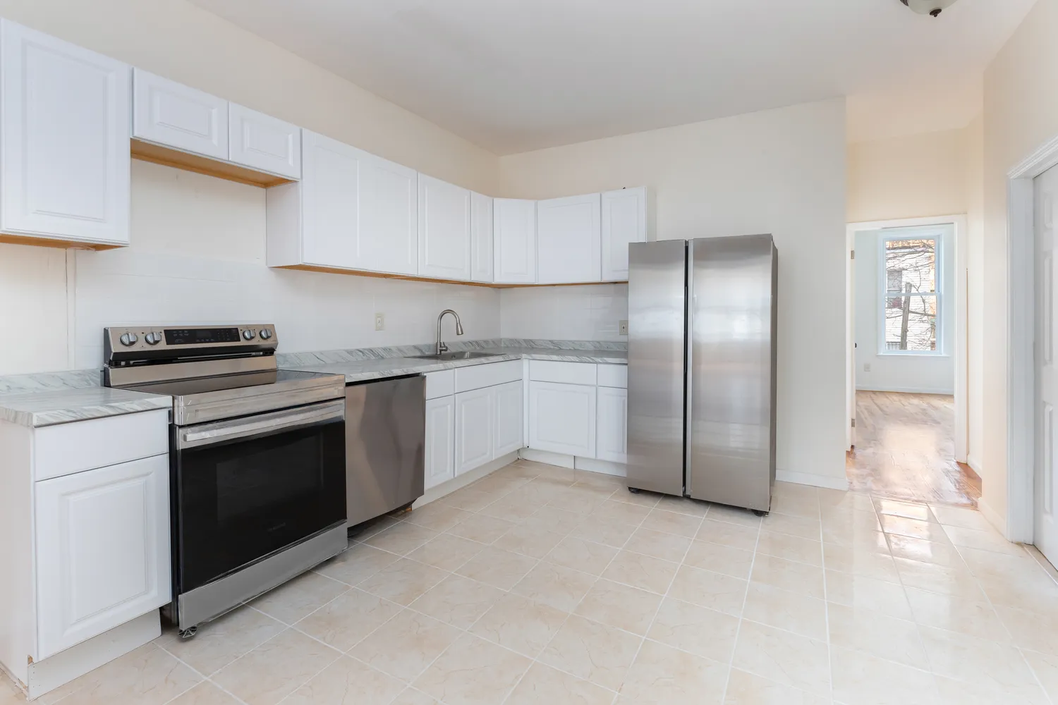 a kitchen with stainless steel appliances granite countertop a stove a sink and a refrigerator