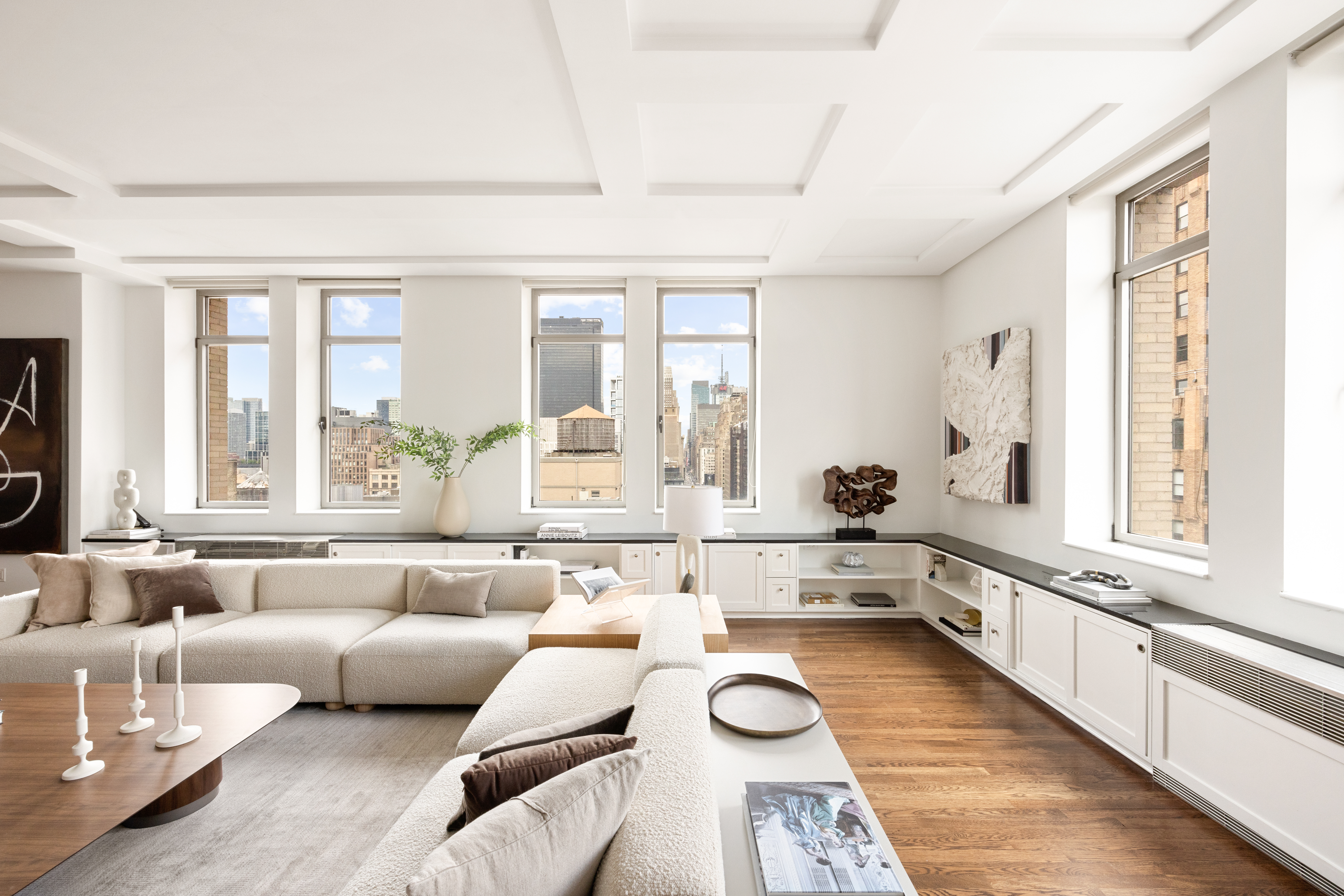 252 7th Avenue, Unit 17I Manhattan, NY 10001 - Photo 4 of 17 a large white open kitchen with stainless steel appliances granite countertop a couch and a large window