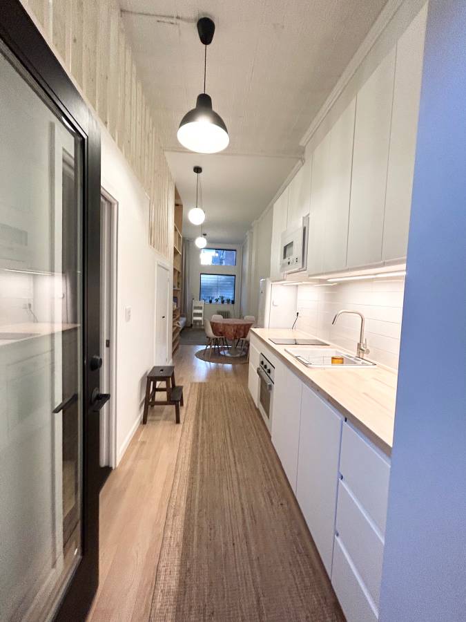 409 Smith Street, Unit 1 Brooklyn, NY 11231 - Photo 6 of 9 a kitchen with stainless steel appliances a refrigerator a sink dishwasher a stove and white cabinets with wooden floor