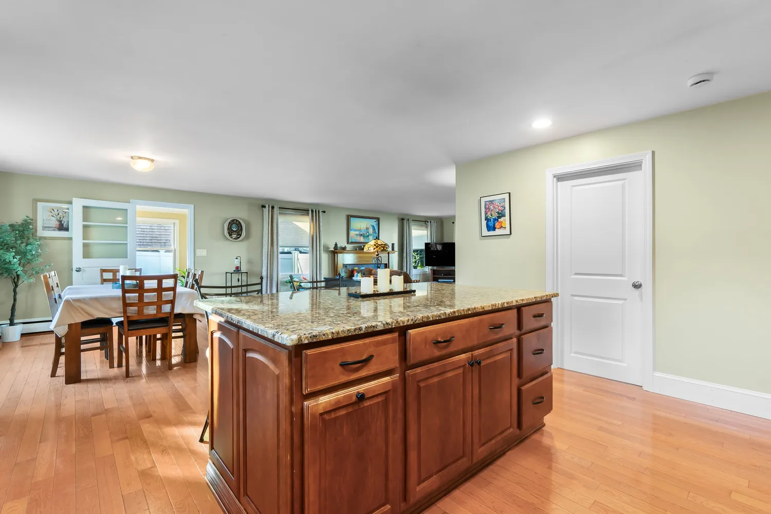 a kitchen with granite countertop a stove cabinets and wooden floor