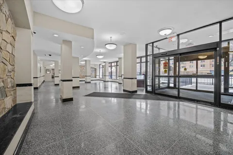 a large white kitchen with lots of counter space wooden floor and windows