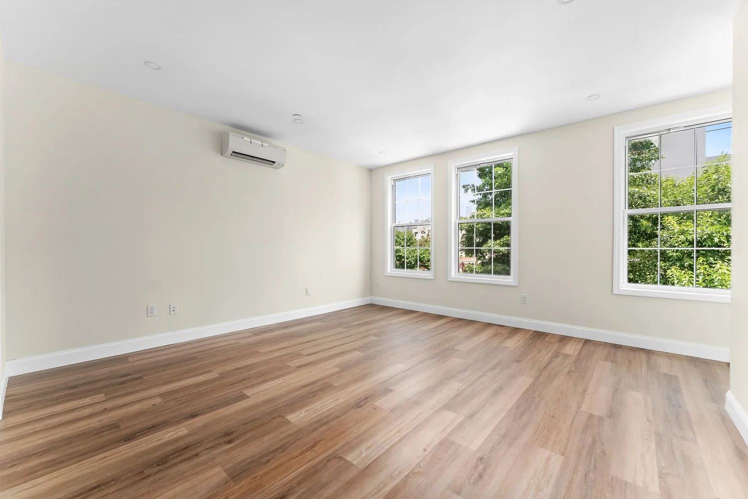 wooden floor in an empty room with a window