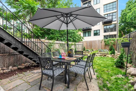 a patio with a patio table and chairs