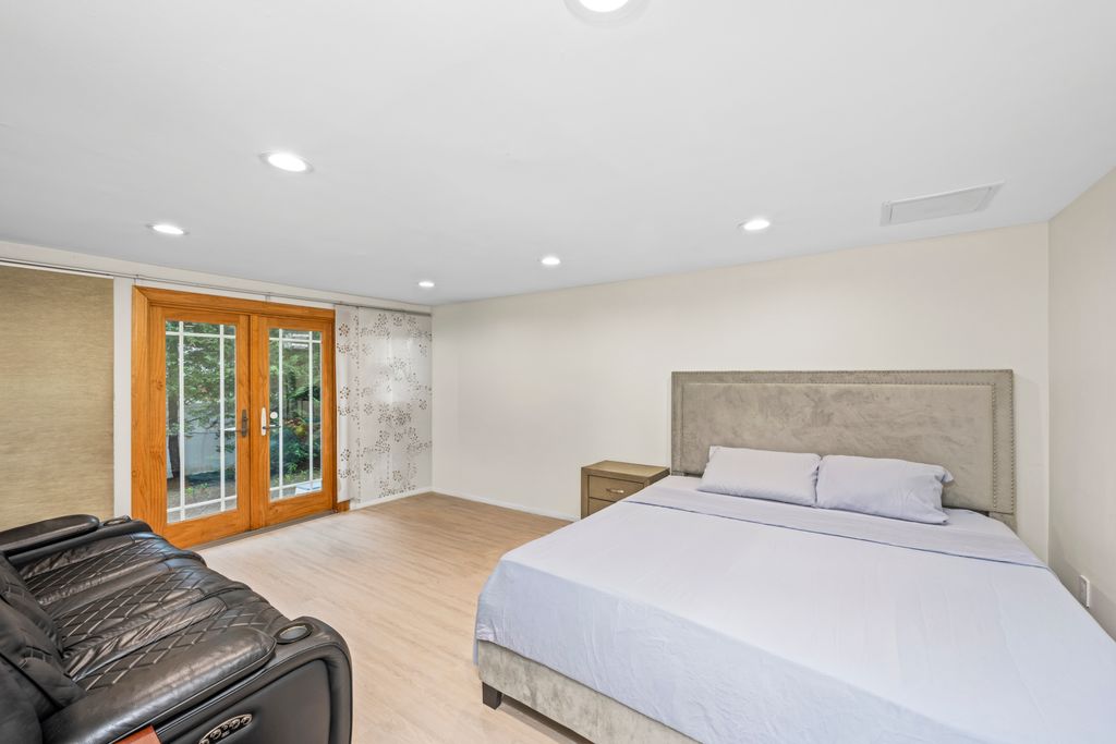 79 Sparkill Avenue Staten Island, NY 10304 - Photo 14 of 32 a bedroom with a large bed and a large window