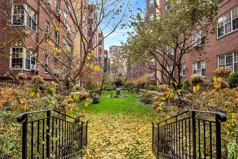 a view of a pathway of a house with a yard