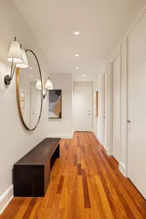 a view of a livingroom with wooden floor and a staircase