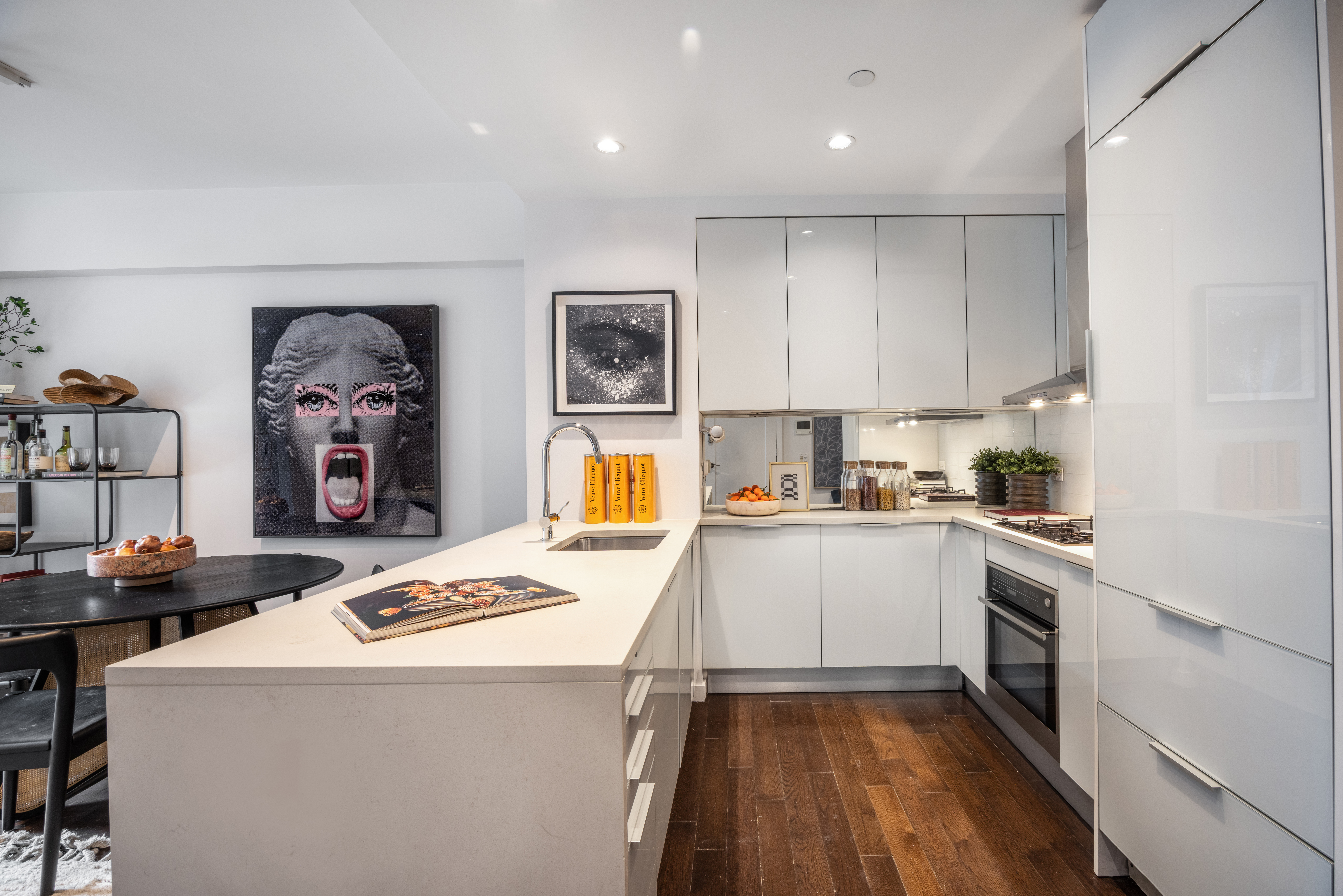 27 West 19th Street, Unit 6 Manhattan, NY 10011 - Photo 4 of 10 a kitchen that has a lot of cabinets a sink and a stove in it