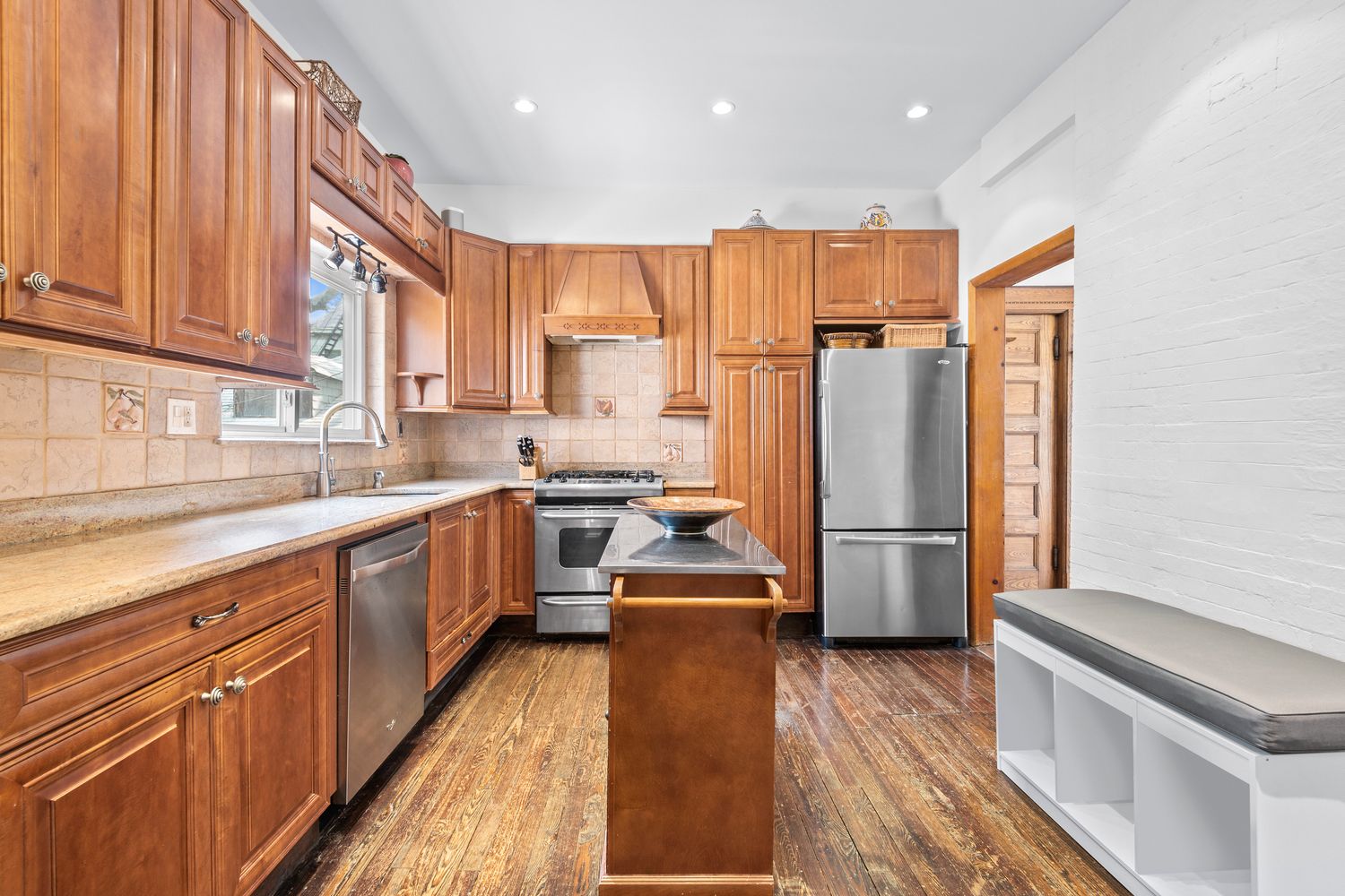 685 East 22nd Street Brooklyn, NY 11210 - Photo 11 of 43 a kitchen with a refrigerator a sink and dishwasher with wooden floor