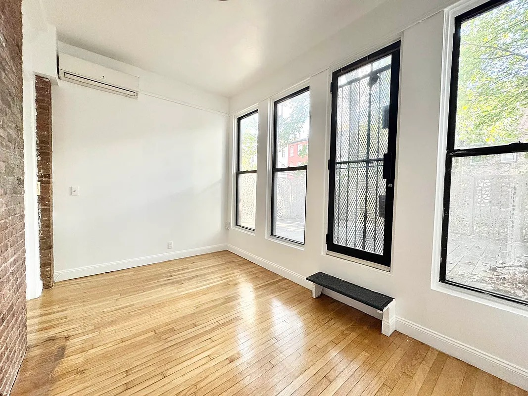 238 Gates Avenue, Unit 2 Brooklyn, NY 11238 - Photo 6 of 13 a view of wooden floor and windows in a room