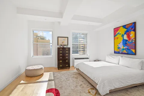 a bedroom with a bed and glass window