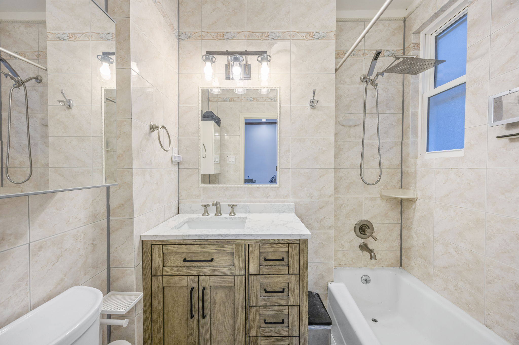 25-69 46th Street Queens, NY 11103 - Photo 23 of 33 a bathroom with a sink vanity granite toilet and shower
