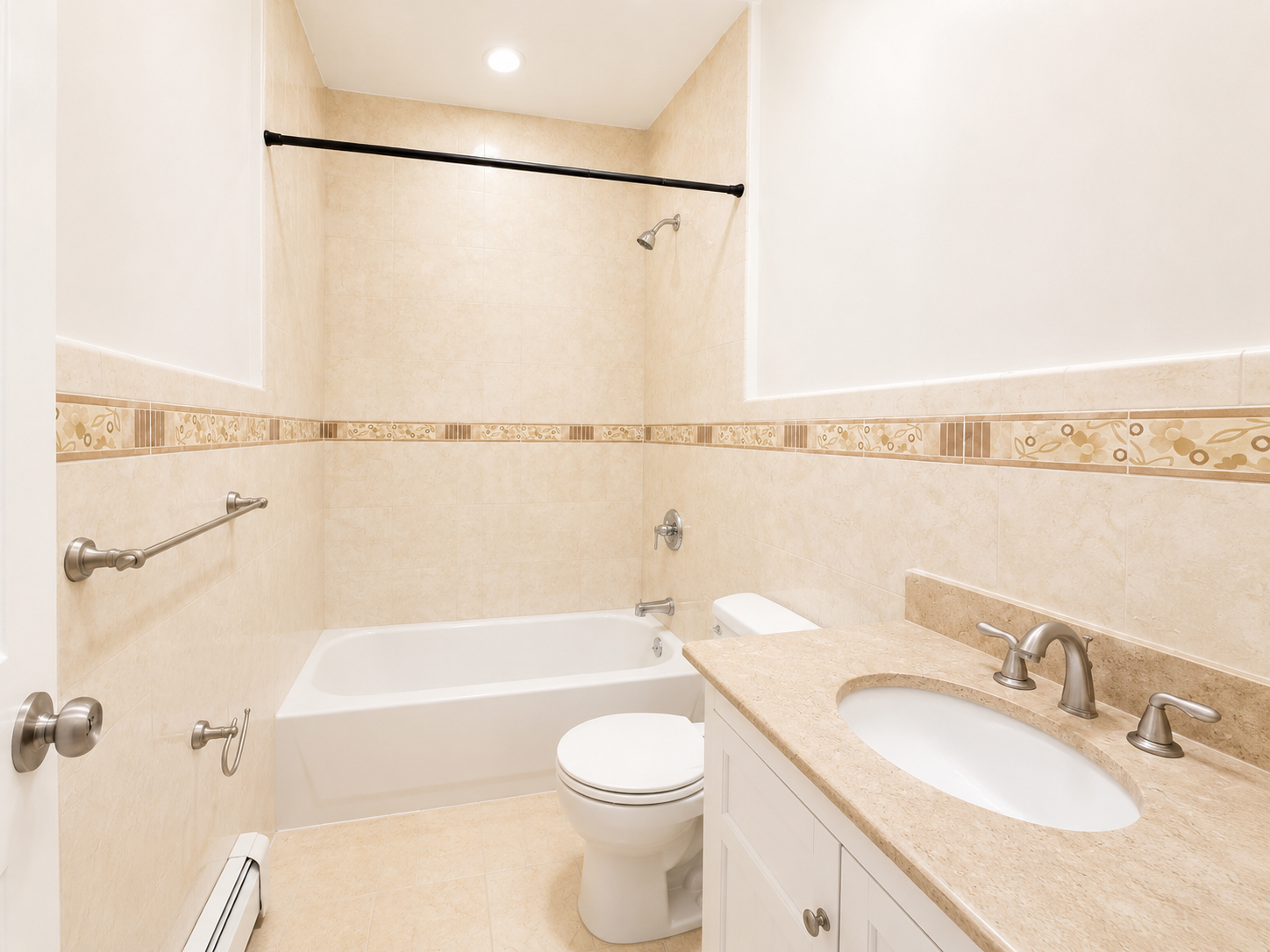 37-15 Broadway, Unit 2 Queens, NY 11103 - Photo 6 of 7 a bathroom with a granite countertop bathtub shower sink vanity and toilet
