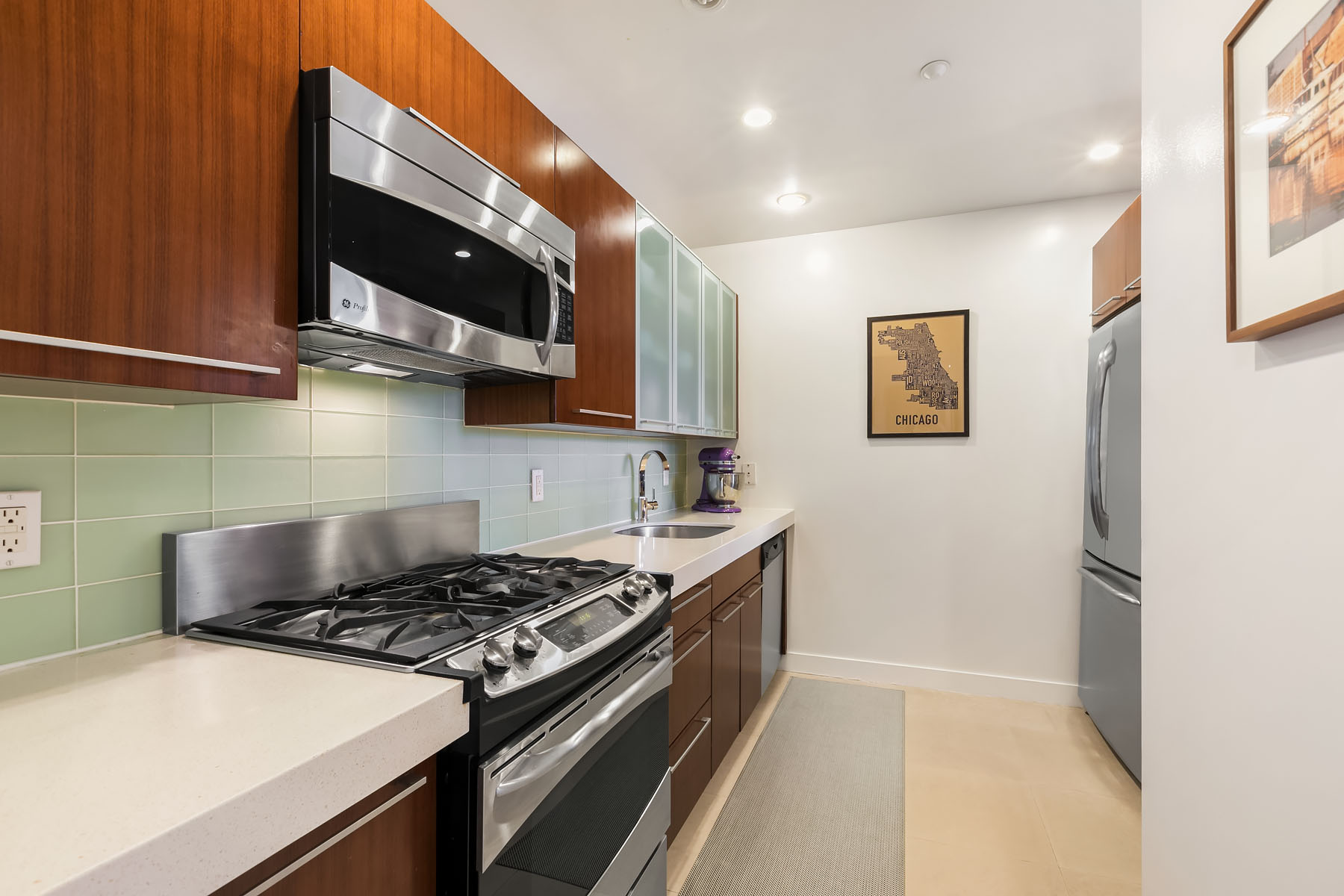 301 West 115th Street, Unit 6J Manhattan, NY 10026 - Photo 3 of 9 a kitchen with stainless steel appliances granite countertop a stove and a microwave