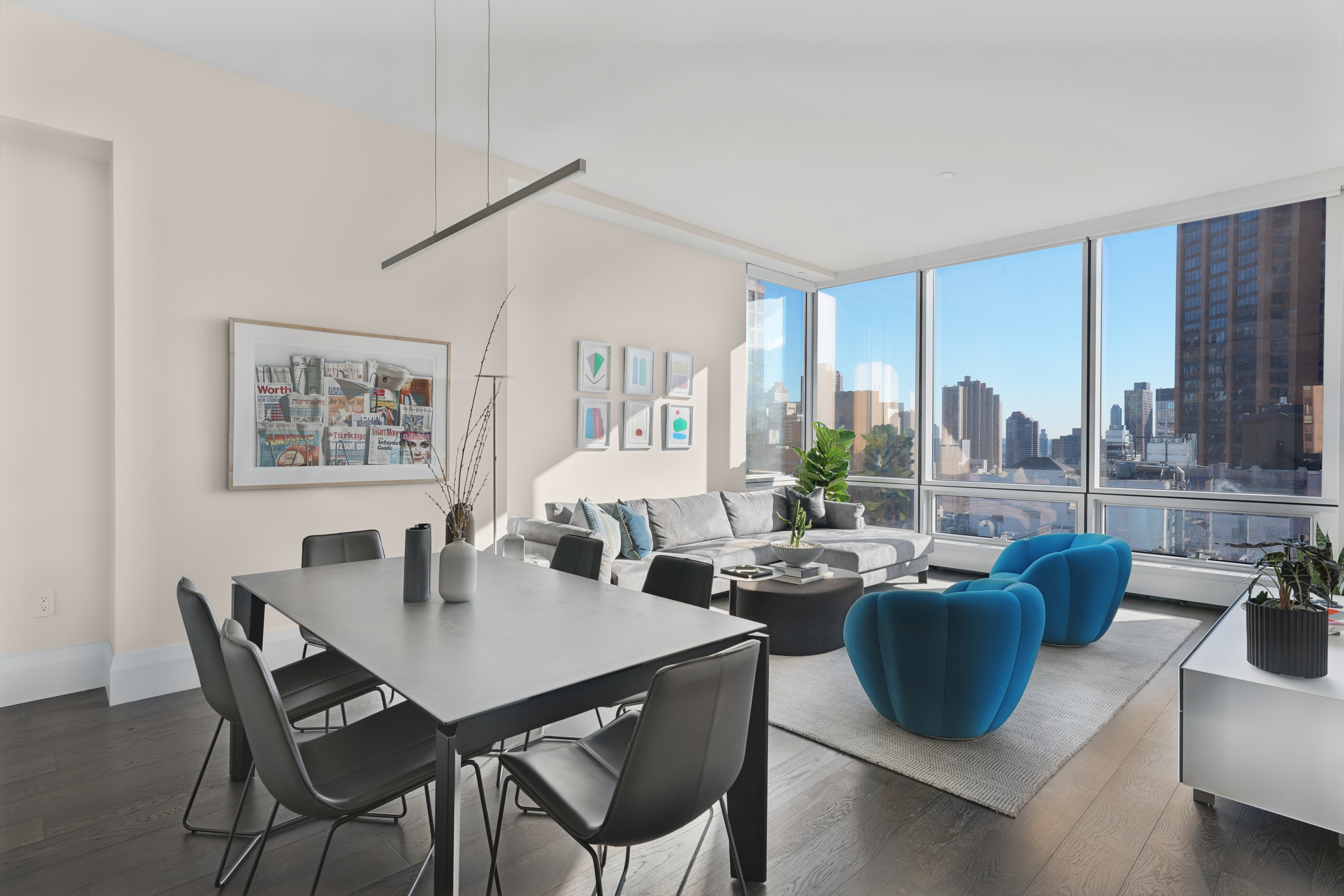 172 Madison Avenue, Unit 24B Manhattan, NY 10016 - Photo 3 of 16 a view of a dining room with furniture large windows and wooden floor