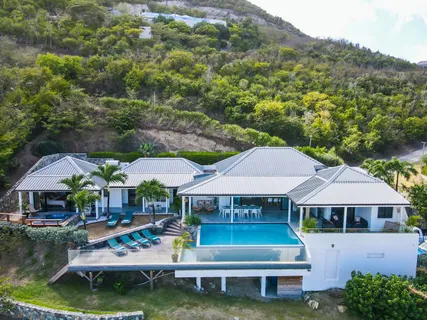 a front view of house with yard and outdoor seating