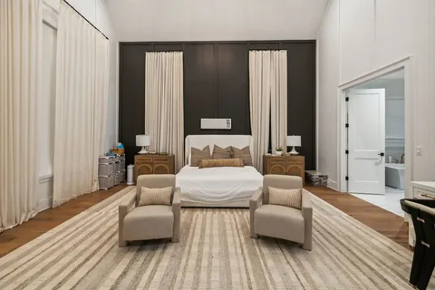 a spacious bedroom with a bed and a couch